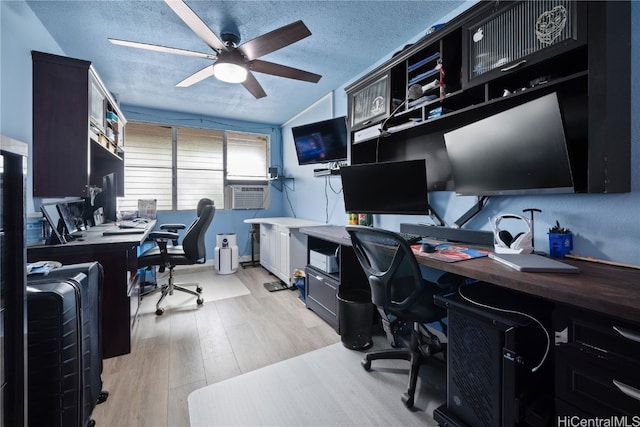 office featuring cooling unit, a textured ceiling, ceiling fan, and light hardwood / wood-style flooring