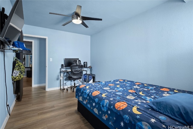 bedroom featuring dark wood-type flooring and ceiling fan