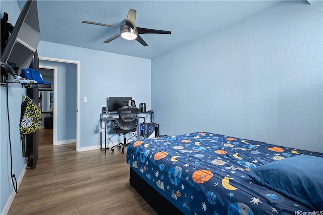 94-1420 Kahuli St, Waipahu, HI 96797 - bedroom featuring wood finished floors, baseboards, a ceiling fan, and a desk