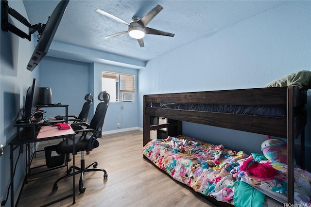 94-1420 Kahuli St, Waipahu, HI 96797 - bedroom with wood finished floors, a desk, baseboards, a textured ceiling, and cooling unit
