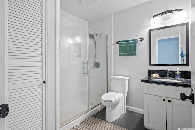 94-1420 Kahuli St, Waipahu, HI 96797 - bathroom featuring toilet, vanity, a shower stall, a textured wall, and baseboards
