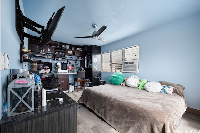 bedroom with ceiling fan, cooling unit, and light hardwood / wood-style floors