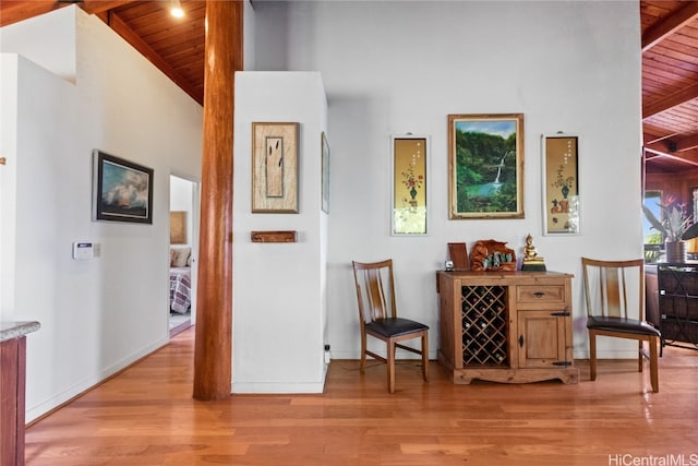 interior space featuring wood ceiling, high vaulted ceiling, beamed ceiling, and light hardwood / wood-style floors