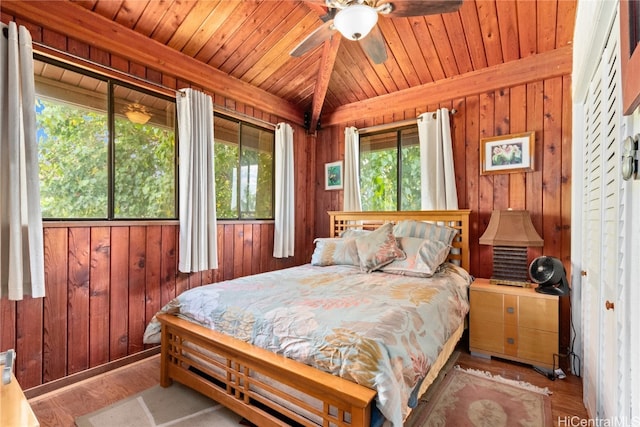 bedroom featuring light hardwood / wood-style floors, multiple windows, wooden walls, and wood ceiling