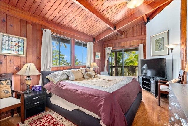 bedroom with vaulted ceiling with beams, light hardwood / wood-style flooring, wood walls, and access to outside