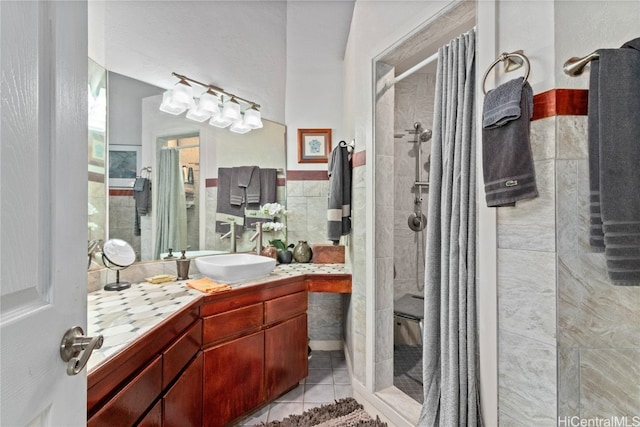 bathroom featuring vanity, tile patterned floors, a shower with shower door, and tile walls