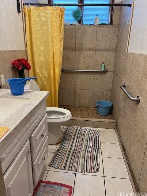 bathroom featuring vanity, tile patterned floors, toilet, and walk in shower