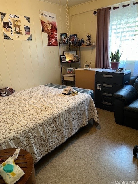 bedroom with wood walls