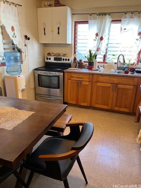 kitchen featuring sink and electric range