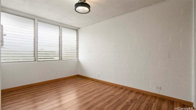 empty room featuring hardwood / wood-style floors and a textured ceiling