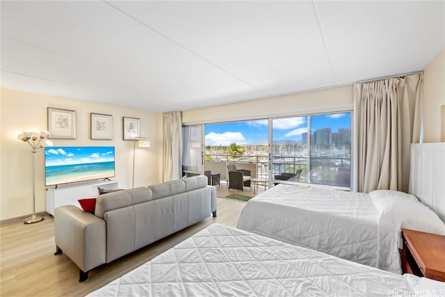 bedroom featuring light hardwood / wood-style floors and access to outside