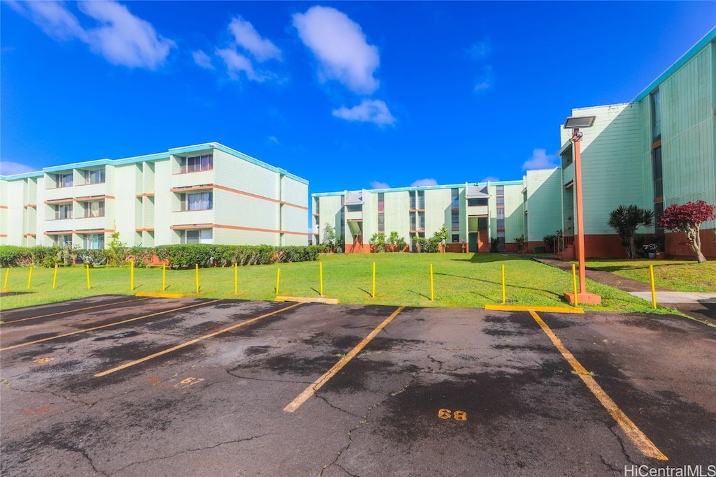 view of car parking featuring a yard