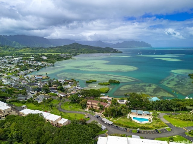 drone / aerial view featuring a water and mountain view