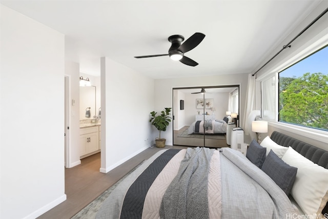 bedroom with dark hardwood / wood-style flooring, a closet, ceiling fan, and ensuite bath