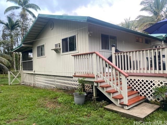 back of house with a yard and a wooden deck