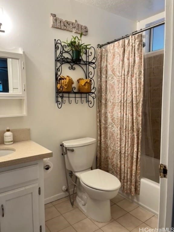 full bathroom with toilet, shower / bath combo with shower curtain, vanity, and tile patterned floors