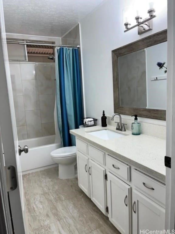 full bathroom featuring vanity, a textured ceiling, toilet, and shower / bathtub combination with curtain