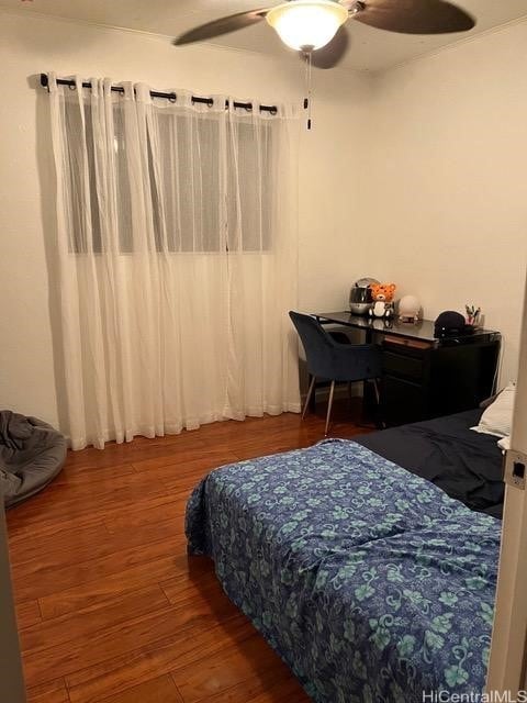 bedroom with ceiling fan and hardwood / wood-style flooring