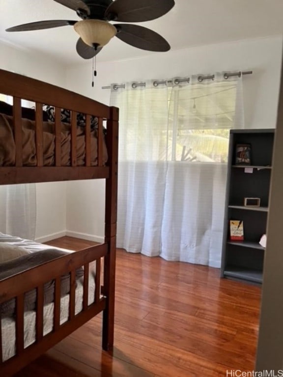 bedroom with hardwood / wood-style flooring and ceiling fan