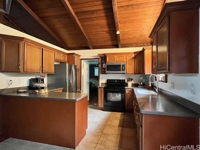 kitchen featuring wood ceiling, sink, lofted ceiling with beams, light tile patterned floors, and appliances with stainless steel finishes