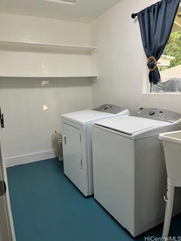 clothes washing area with washing machine and clothes dryer