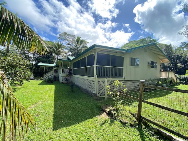 back of house featuring a sunroom