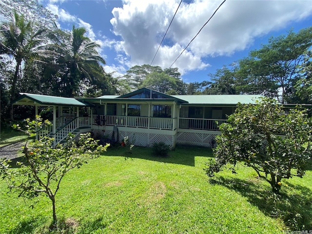 back of property with a yard and stairs