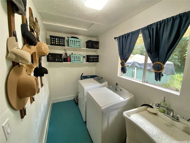 clothes washing area with washing machine and dryer