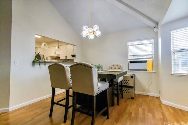 dining area featuring light hardwood / wood-style flooring, cooling unit, a chandelier, and beam ceiling