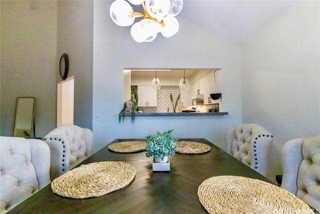 dining space featuring a chandelier and vaulted ceiling