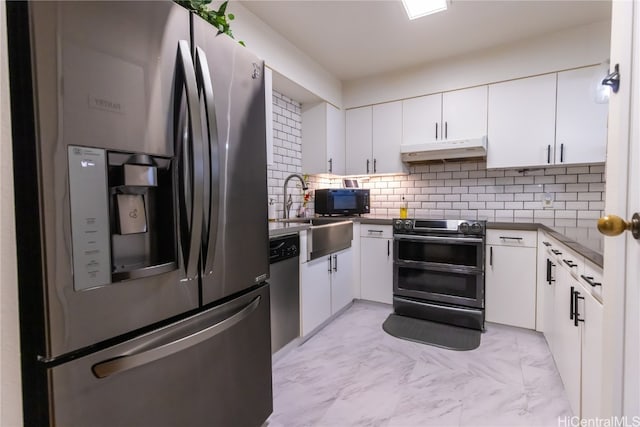 kitchen featuring white cabinetry, sink, backsplash, and appliances with stainless steel finishes