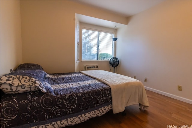 bedroom with hardwood / wood-style flooring