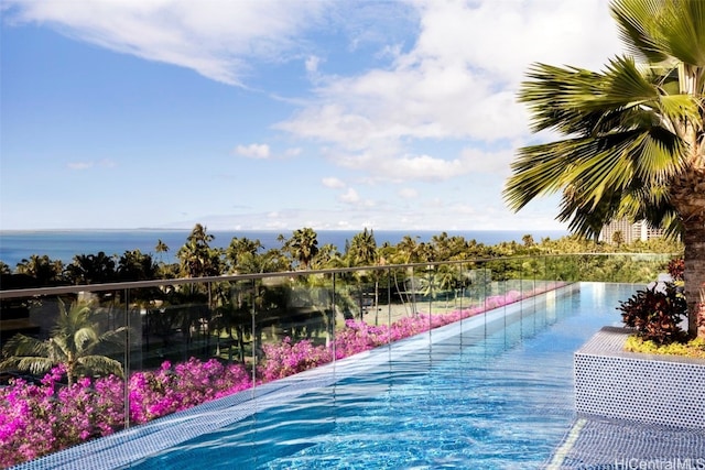 view of swimming pool featuring a water view