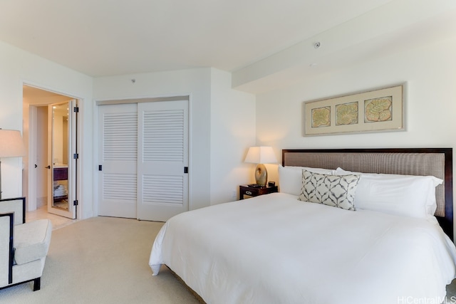 bedroom with a closet and light colored carpet