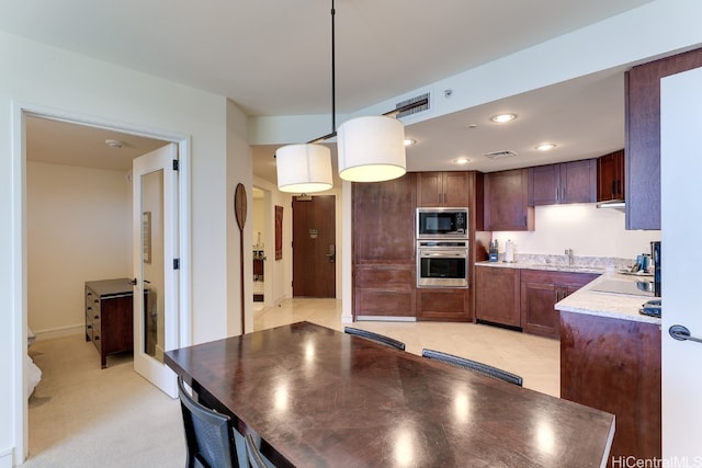 kitchen featuring sink, light tile patterned floors, appliances with stainless steel finishes, and decorative light fixtures