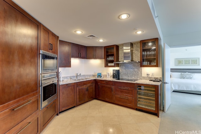 kitchen with wall chimney range hood, stainless steel appliances, wine cooler, sink, and light stone counters