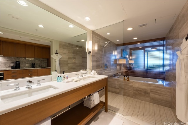 bathroom with vanity, separate shower and tub, tile walls, and tile patterned flooring