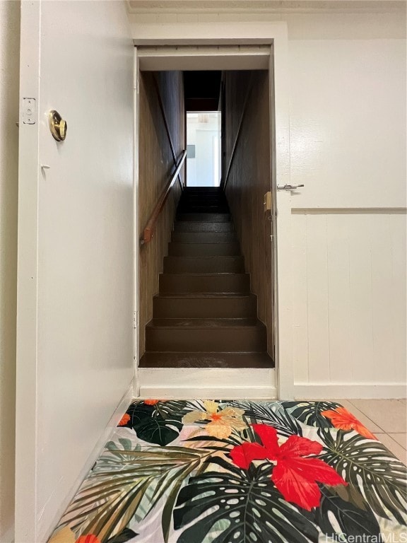 stairway with tile patterned flooring