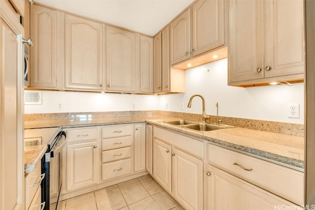 kitchen featuring sink, range with electric stovetop, light tile patterned flooring, light stone countertops, and light brown cabinets