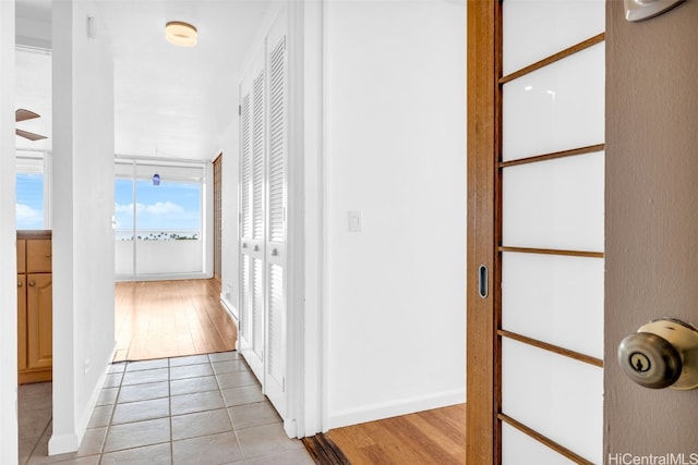 hallway with light hardwood / wood-style floors