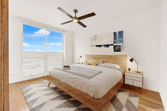 bedroom with ceiling fan and light wood-type flooring