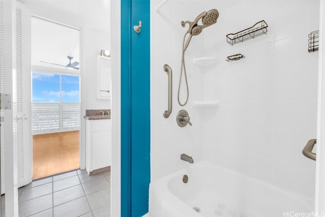 bathroom featuring hardwood / wood-style floors, vanity, tiled shower / bath combo, and ceiling fan