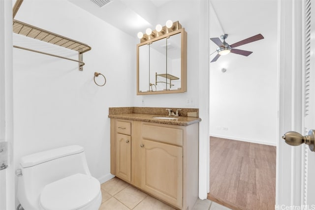 bathroom with vanity, hardwood / wood-style flooring, toilet, and ceiling fan