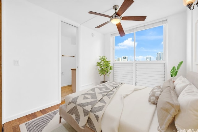 bedroom with ceiling fan and light hardwood / wood-style flooring