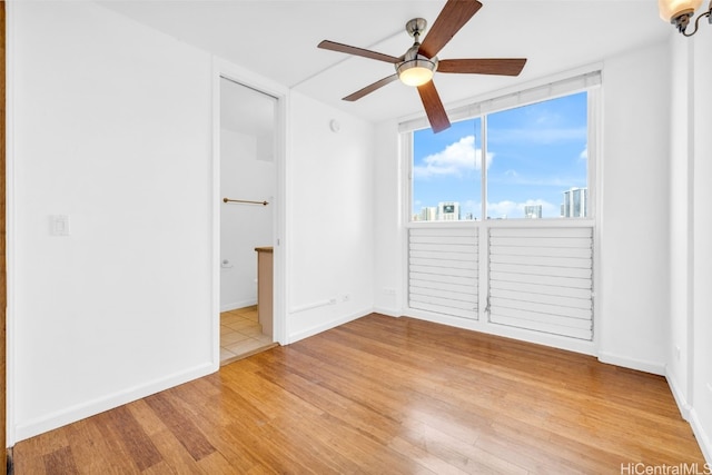 spare room with light hardwood / wood-style floors and ceiling fan