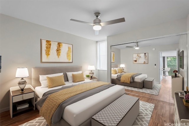 bedroom featuring a closet, baseboards, wood finished floors, and a ceiling fan