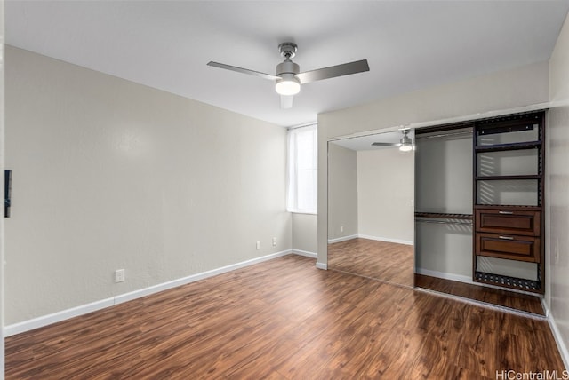 unfurnished bedroom featuring baseboards, wood finished floors, and a ceiling fan