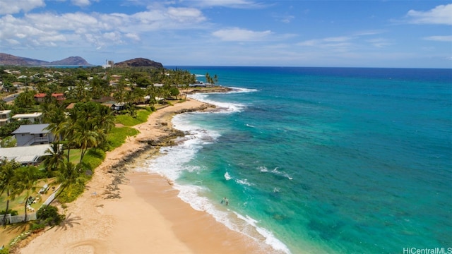 birds eye view of property with a beach view and a water view