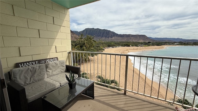 balcony with a water and mountain view and a view of the beach