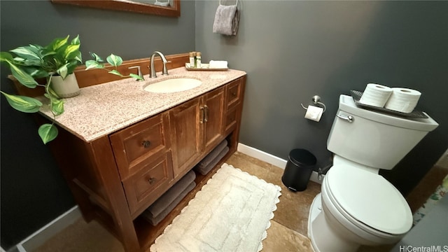 bathroom featuring tile patterned floors, vanity, and toilet